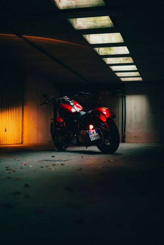 a motorcycle parked in an industrial garage at night
