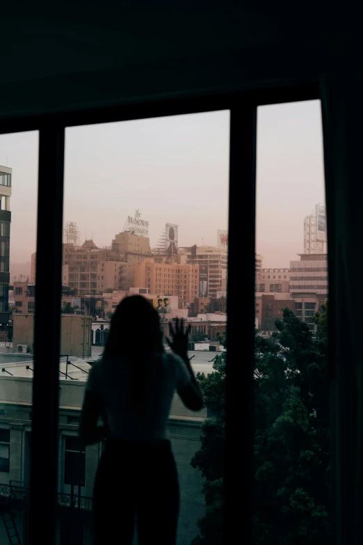 view of city with building and person in window