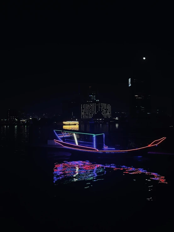 a boat floating on a river at night