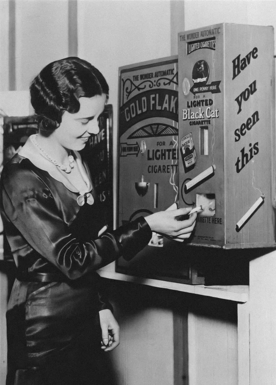 black and white po of woman standing near machine