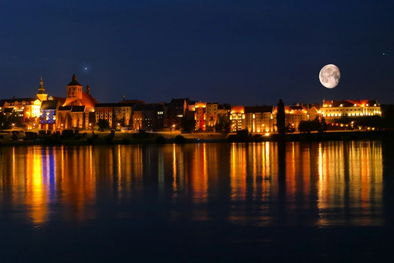 the moon is shining in the sky over the buildings