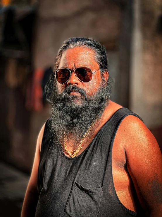 a man with sunglasses and a beard on his head