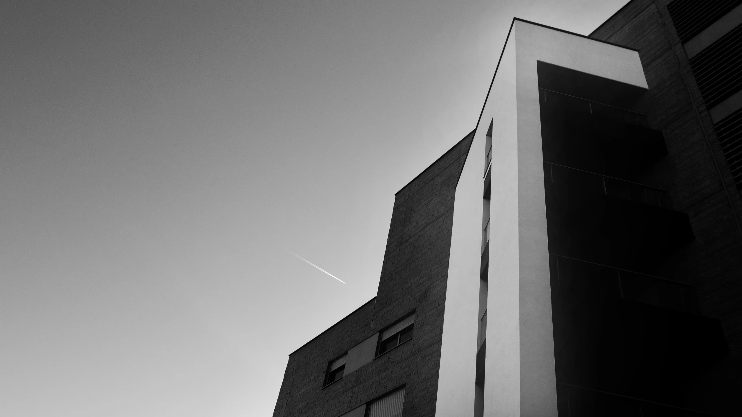 a clock sitting on the side of a tall building