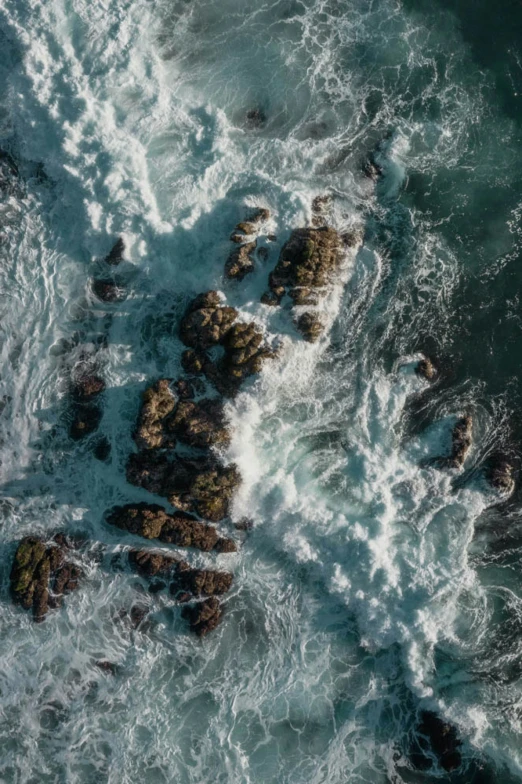 water is splashing on rocks in the ocean