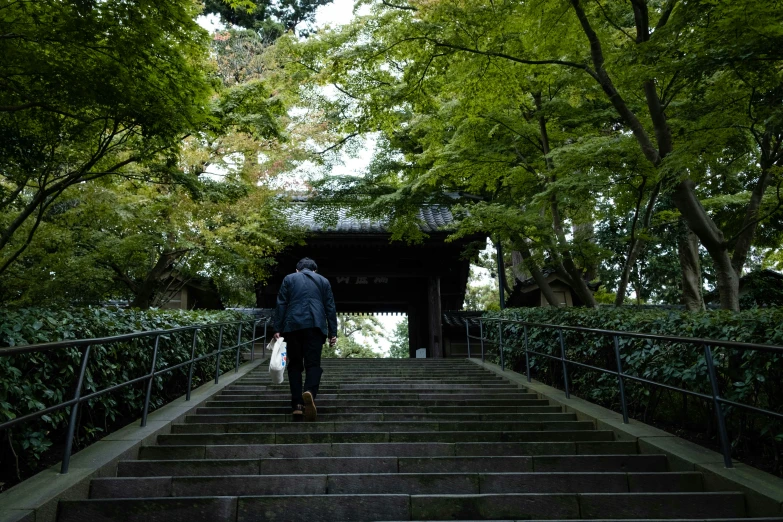 a man walks down some steps in the rain