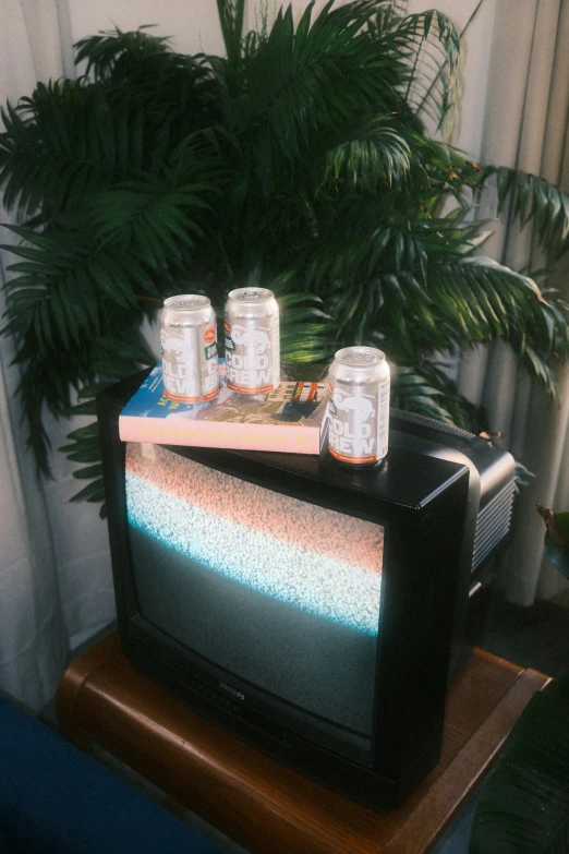 two glasses on top of an old television