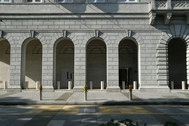 a large gray stone building with arched doors