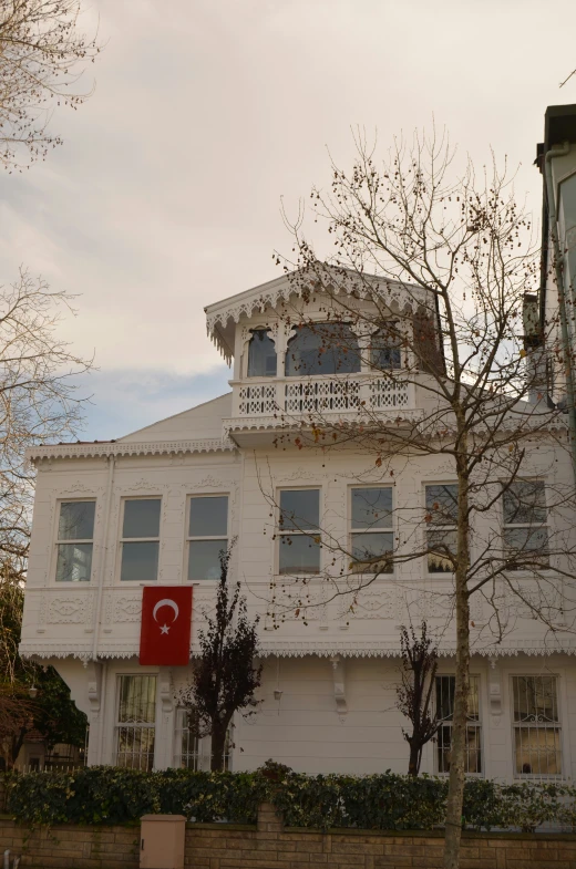 a very large white building with a red sign in front