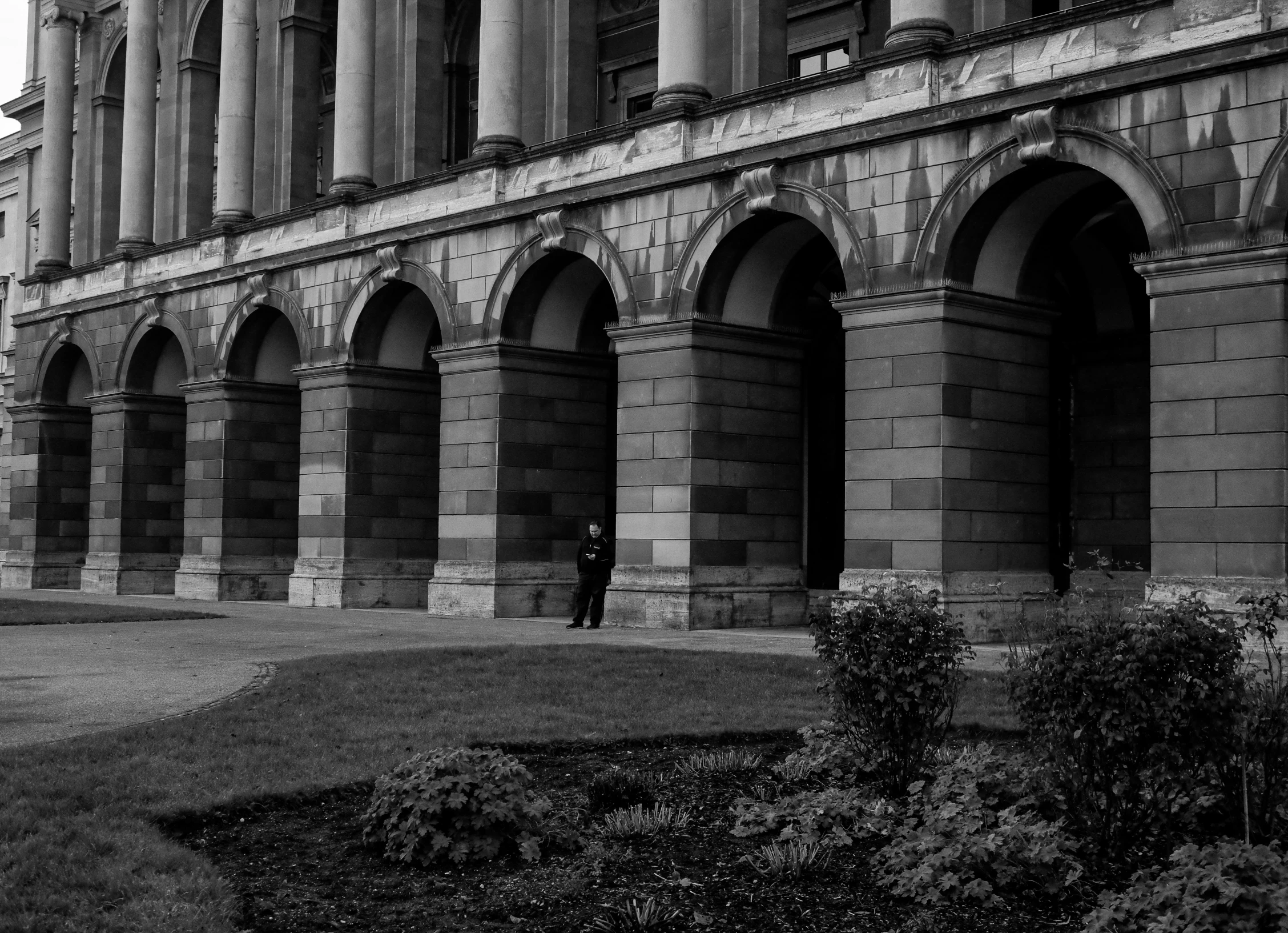 a stone building with arches in front of it