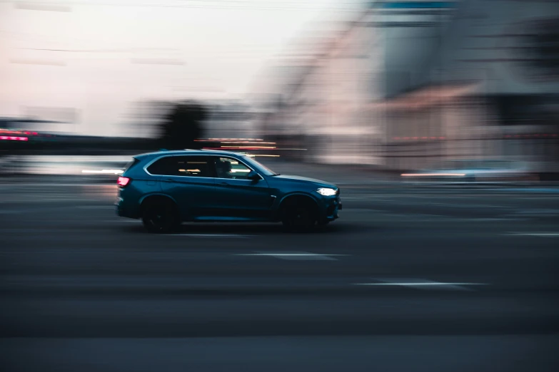 the blue car is driving down the city street