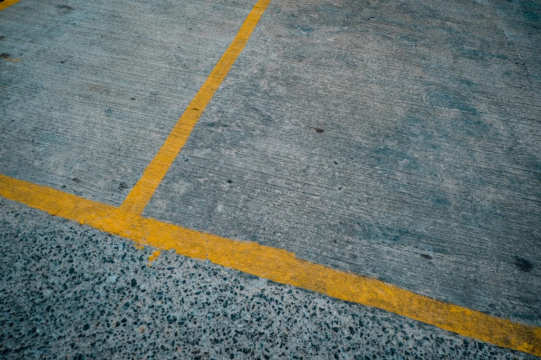 a yellow line painted on the side of a parking lot
