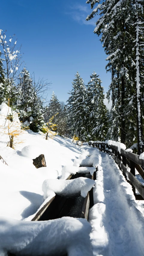 a snowy road on a hill in the mountains