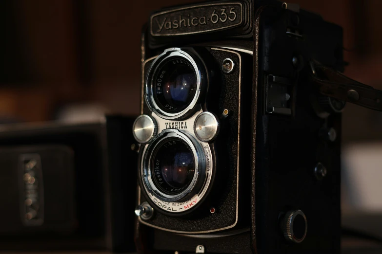 a very old style camera sits near another one