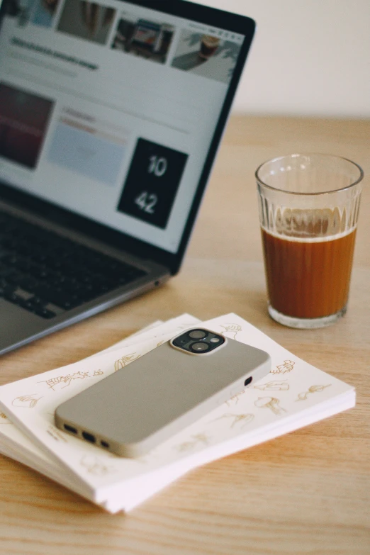 a book, coffee glass and cell phone on a table