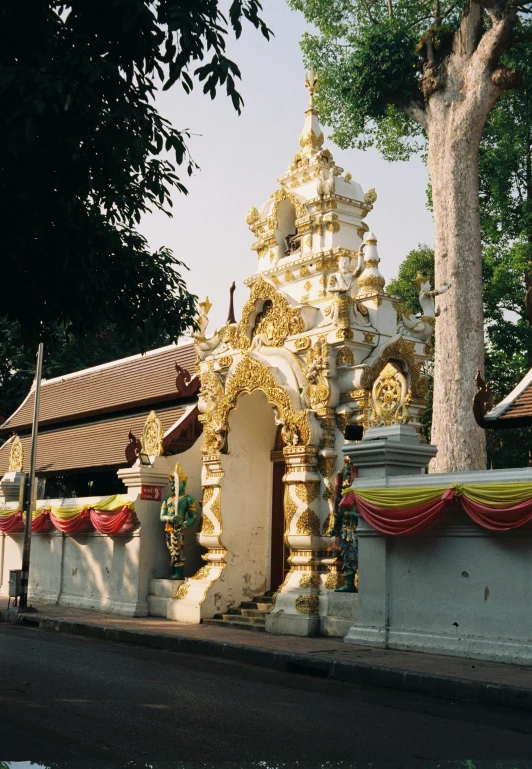 an outdoor temple with many statues around it