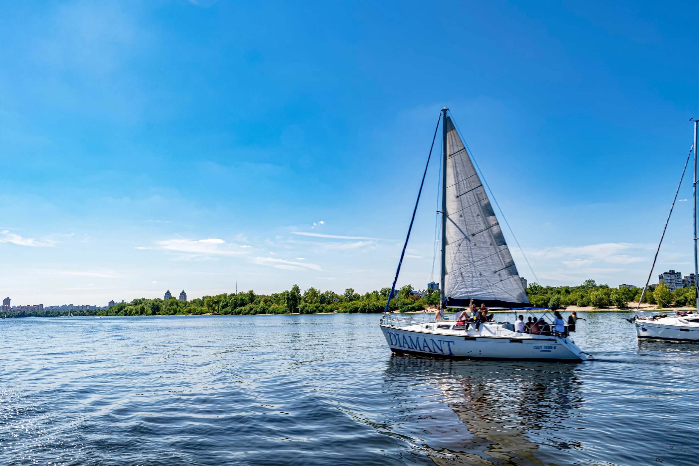 three boats floating on top of a lake