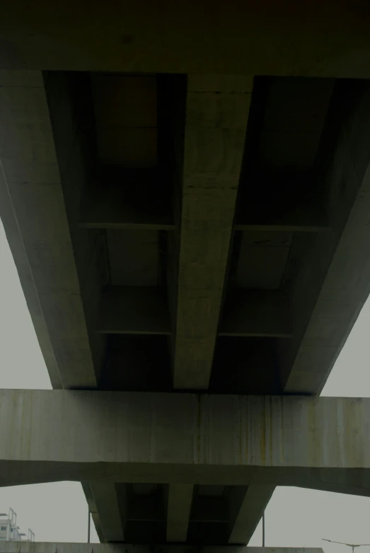 an overhead view from underneath a bridge over a street