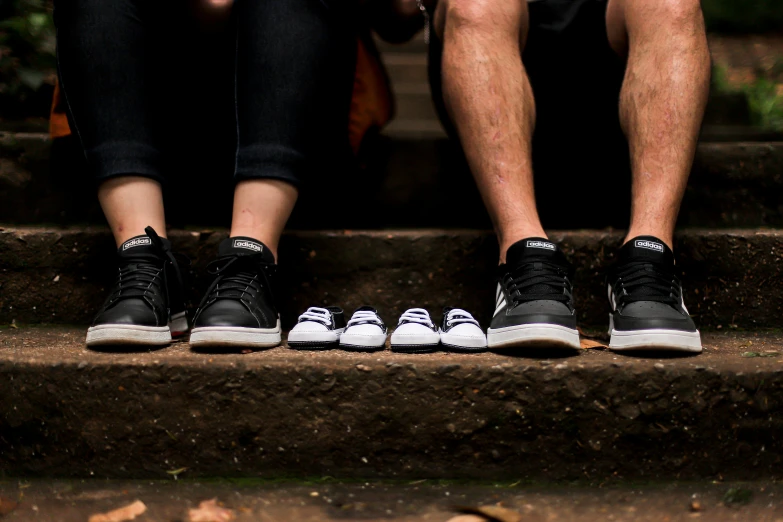 three people standing in front of a cement step