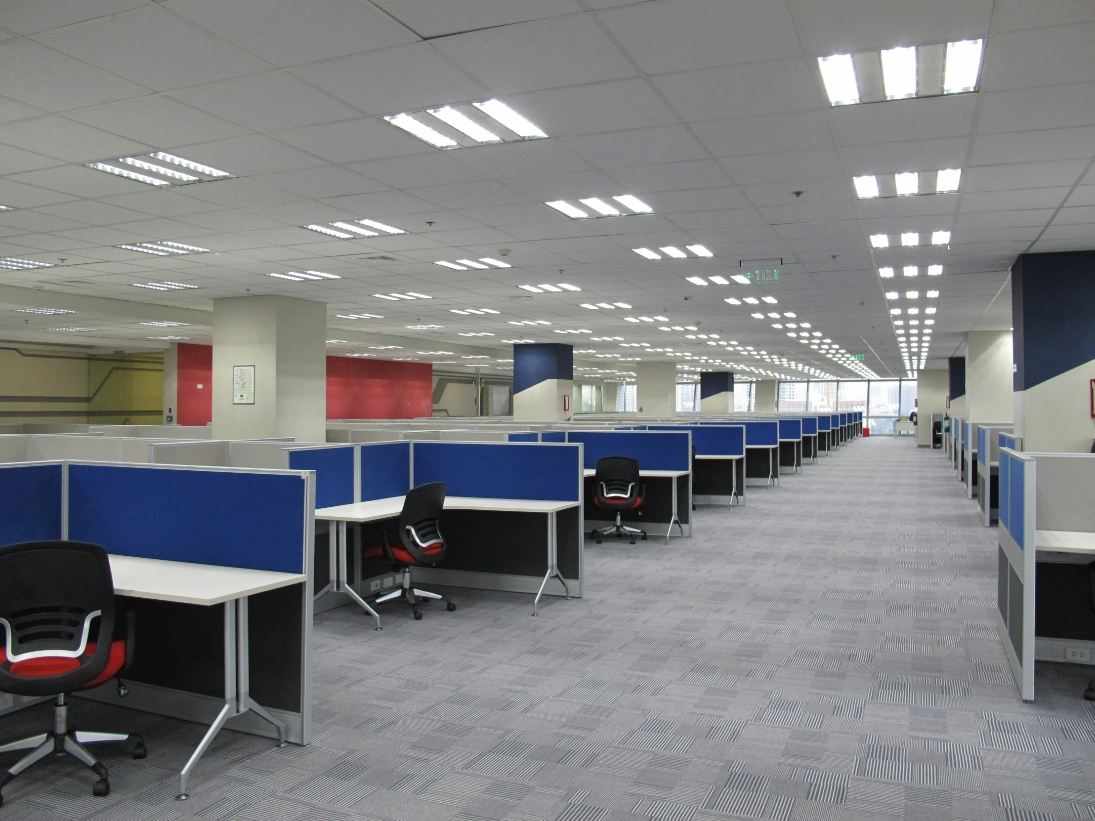 a large office with blue and white walls and a checkered pattern floor