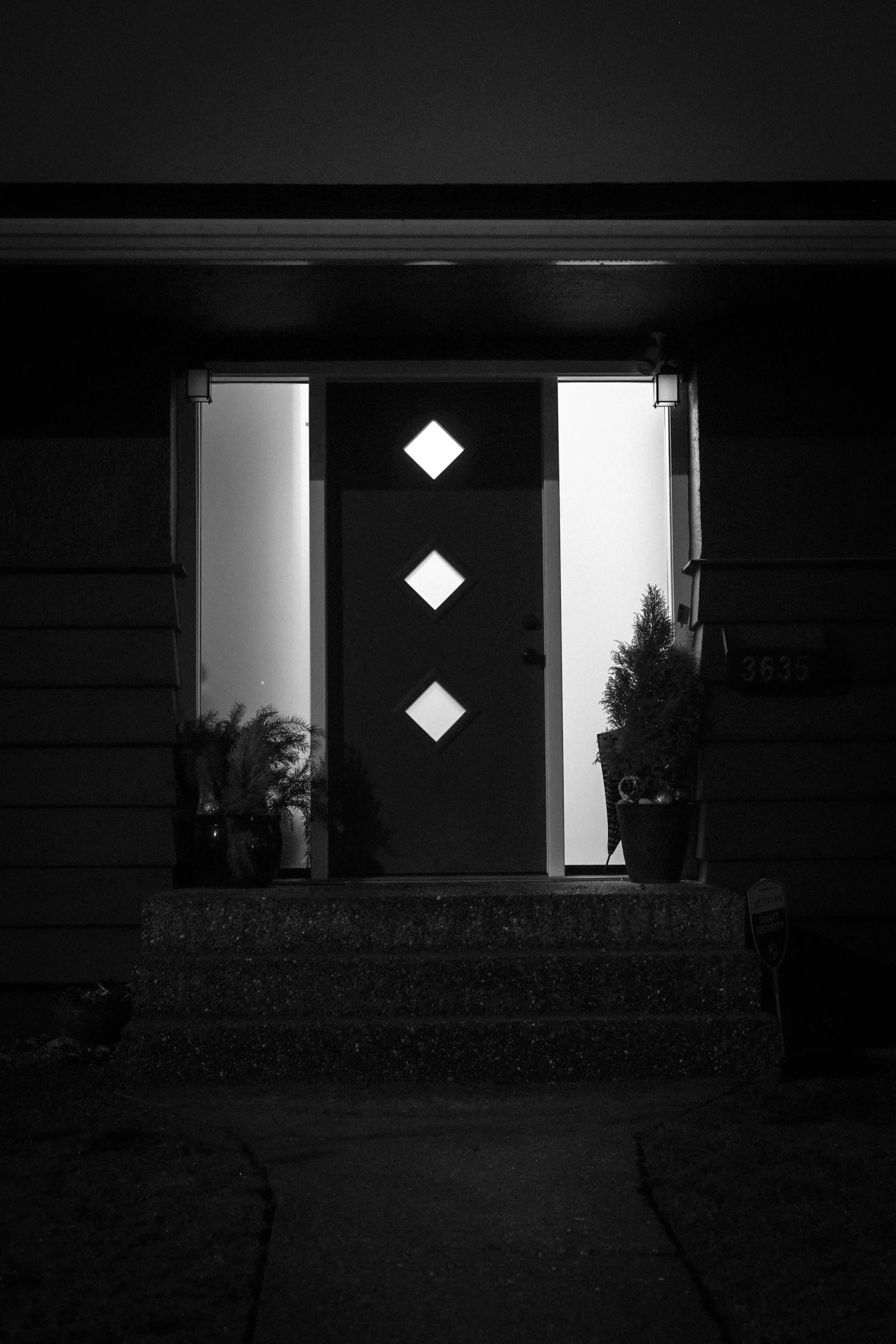 a building with an open front door and three diamonds on it