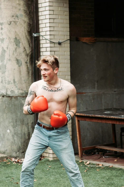 a man with red boxing gloves on hitting the ball