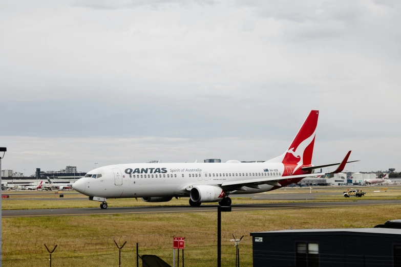 two white and red airplanes on an airport runway