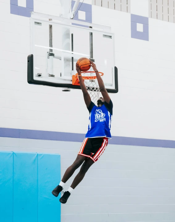 a basketball player dunking a ball into the hoop