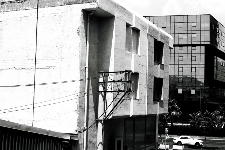 an old building with a satellite dish suspended from it's side