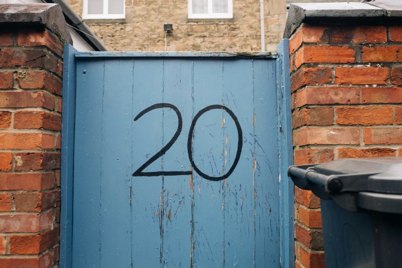 there is a blue door with the number 20 painted on it