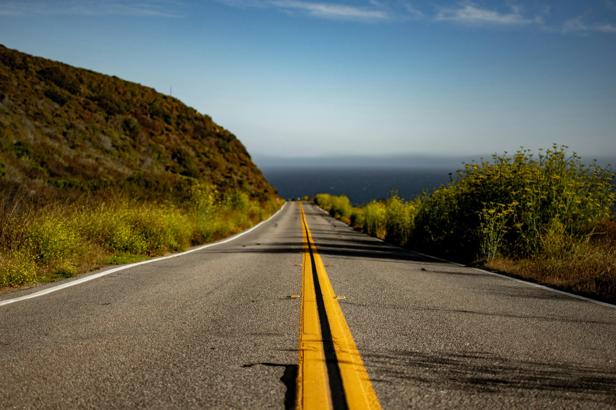 a large hill that is next to the road