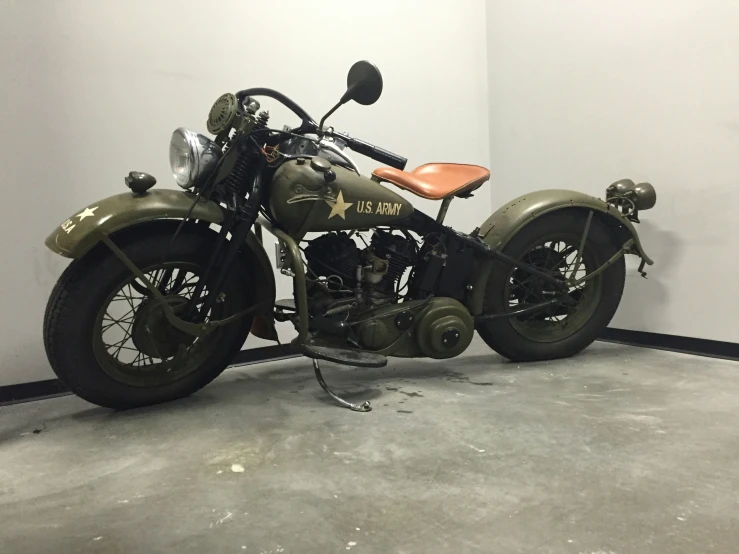 a motorcycle parked in a large building next to a wall