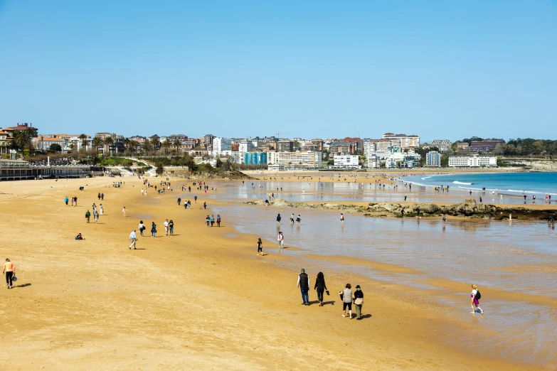 beach with people walking around on sunny day