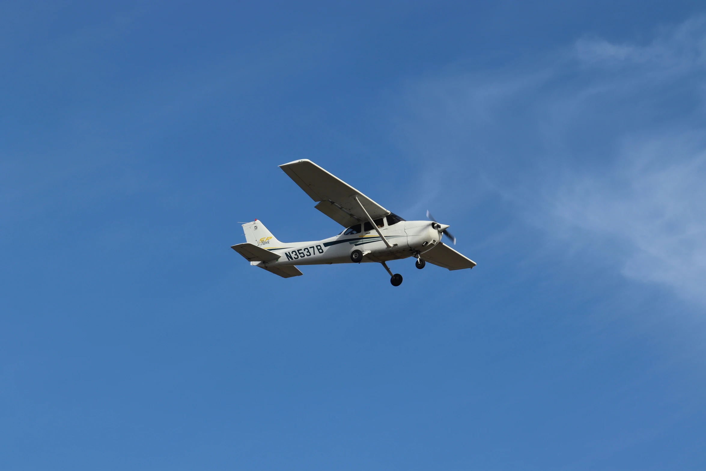 the small airplane is flying through the air