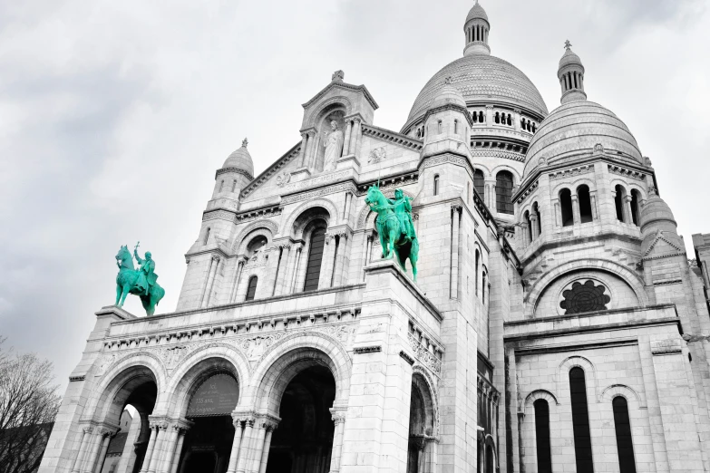 a church with statues sitting on the steeples