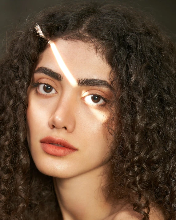 a close up of a person with curly hair