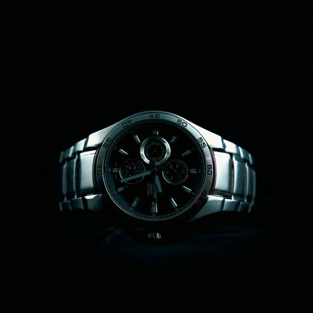 a watch against a black background