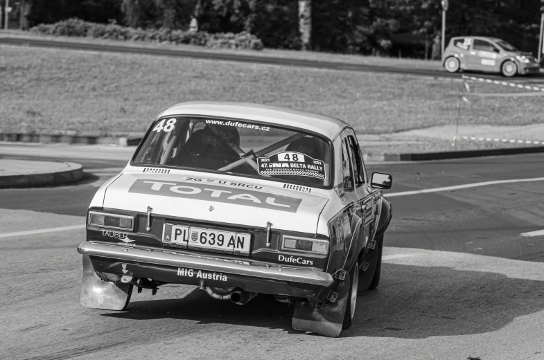 a car drifting on a race track with a man driving