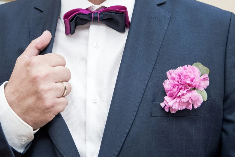 a close up of a person with a flower in his lapel