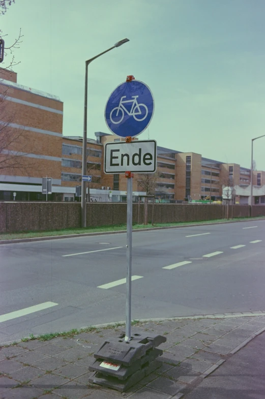 the street sign shows the name of the bicycle lane