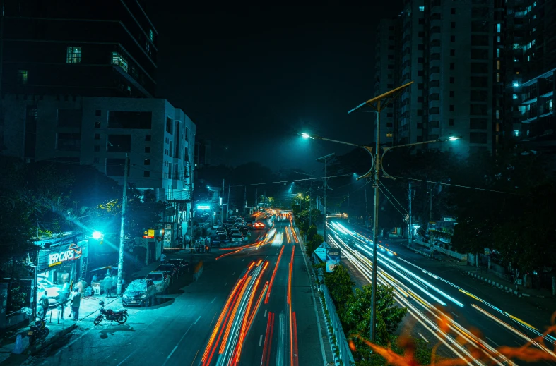 traffic passing by in a busy intersection at night