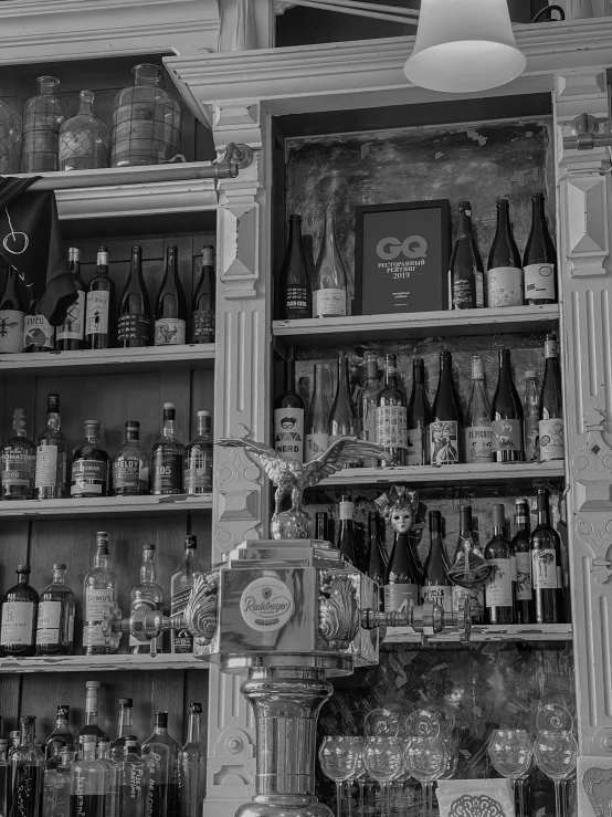 several old fashioned shelves full of liquor bottles