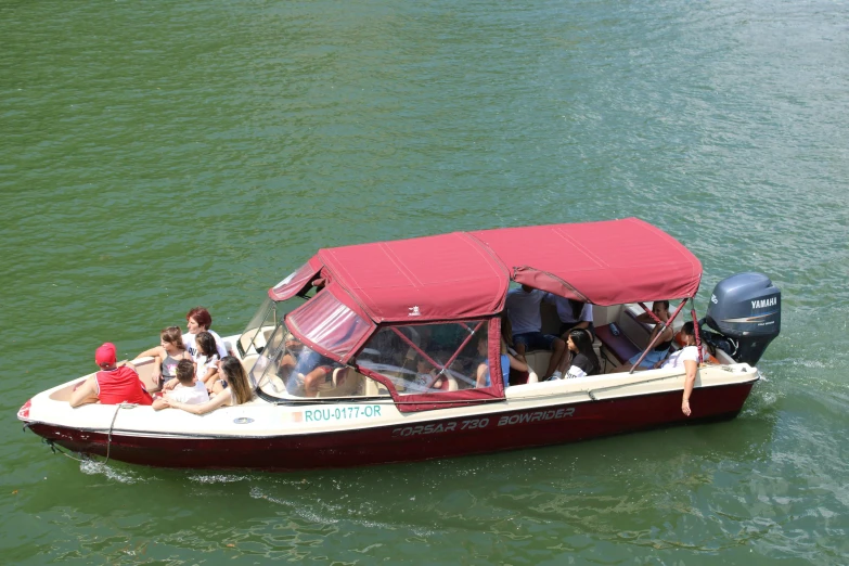 four people are riding on the boat in a body of water