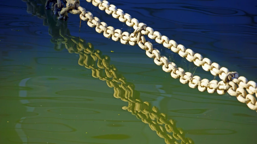 a chain hanging over a body of water