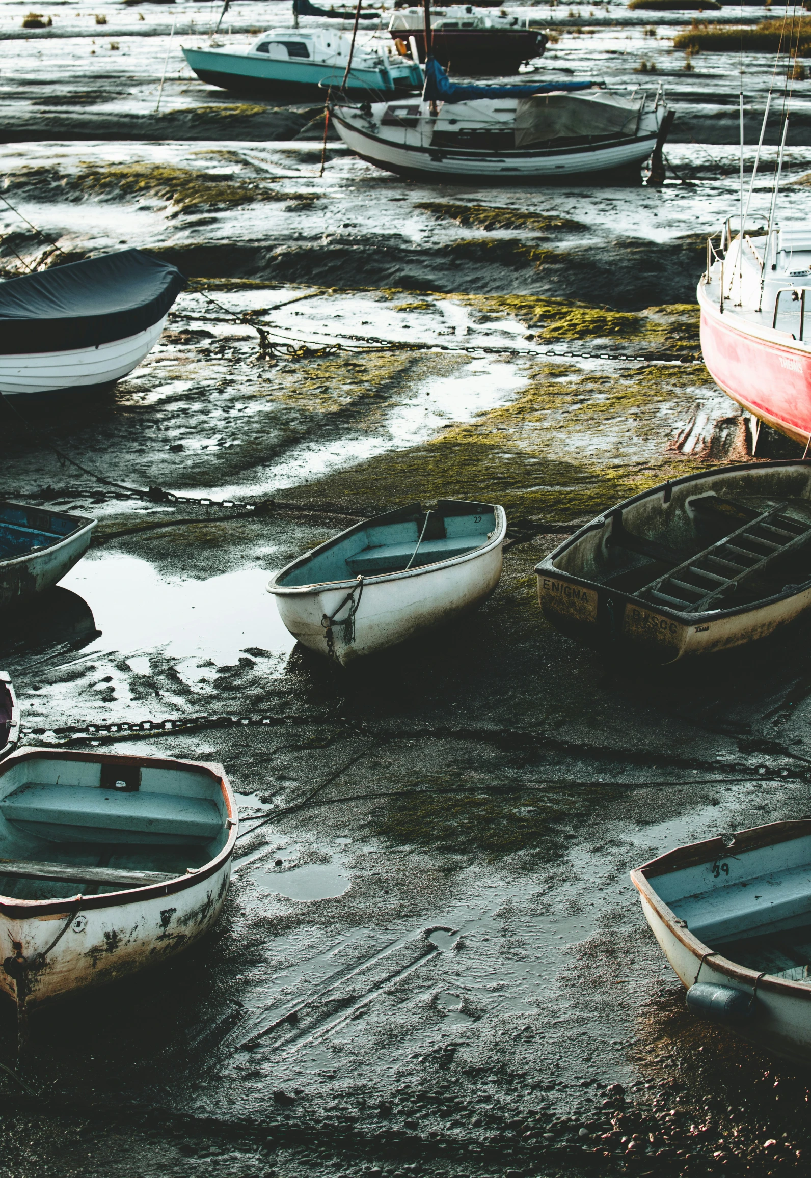 some small boats sitting in the sand near the water