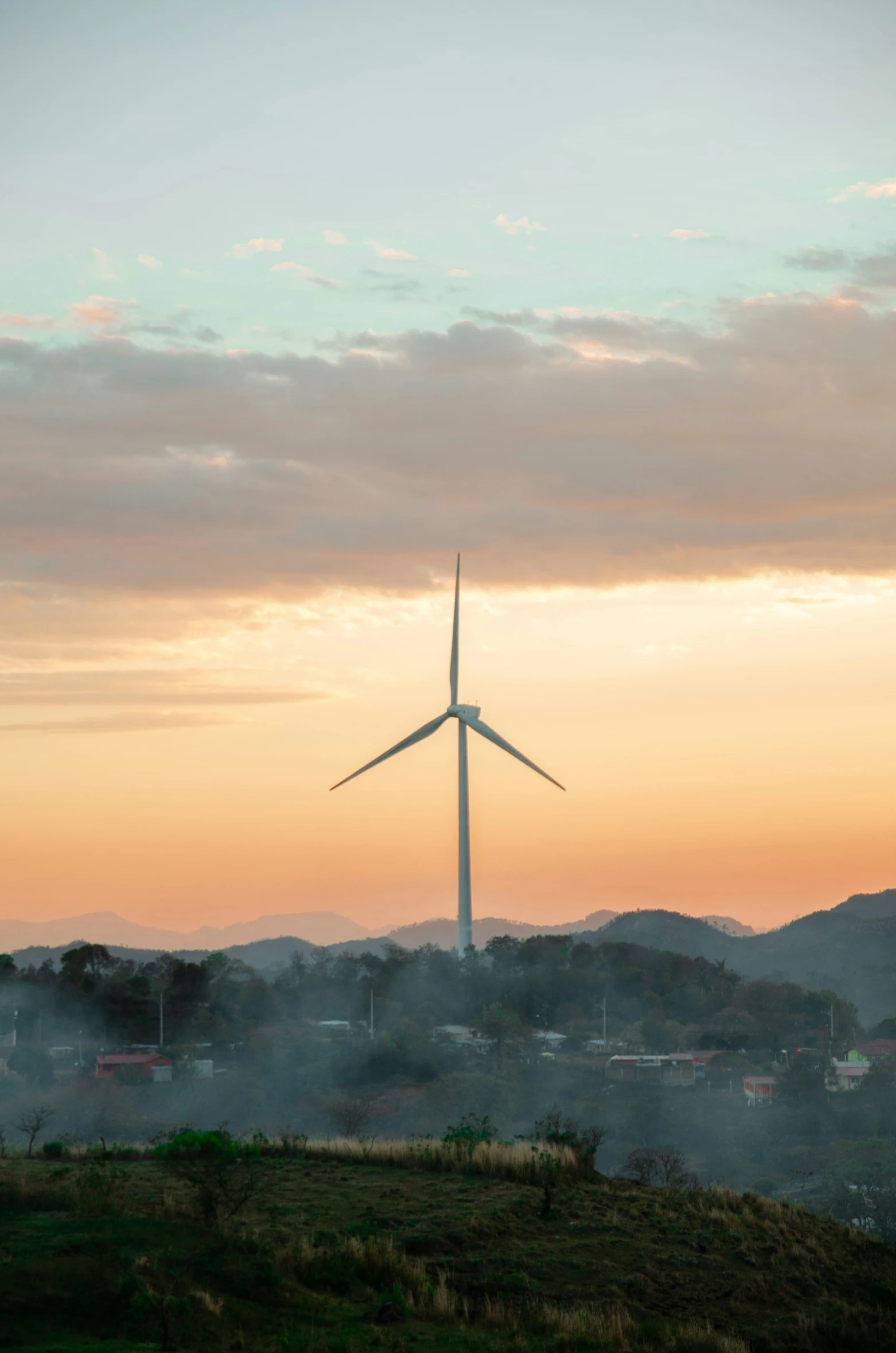 a wind farm near a city with buildings