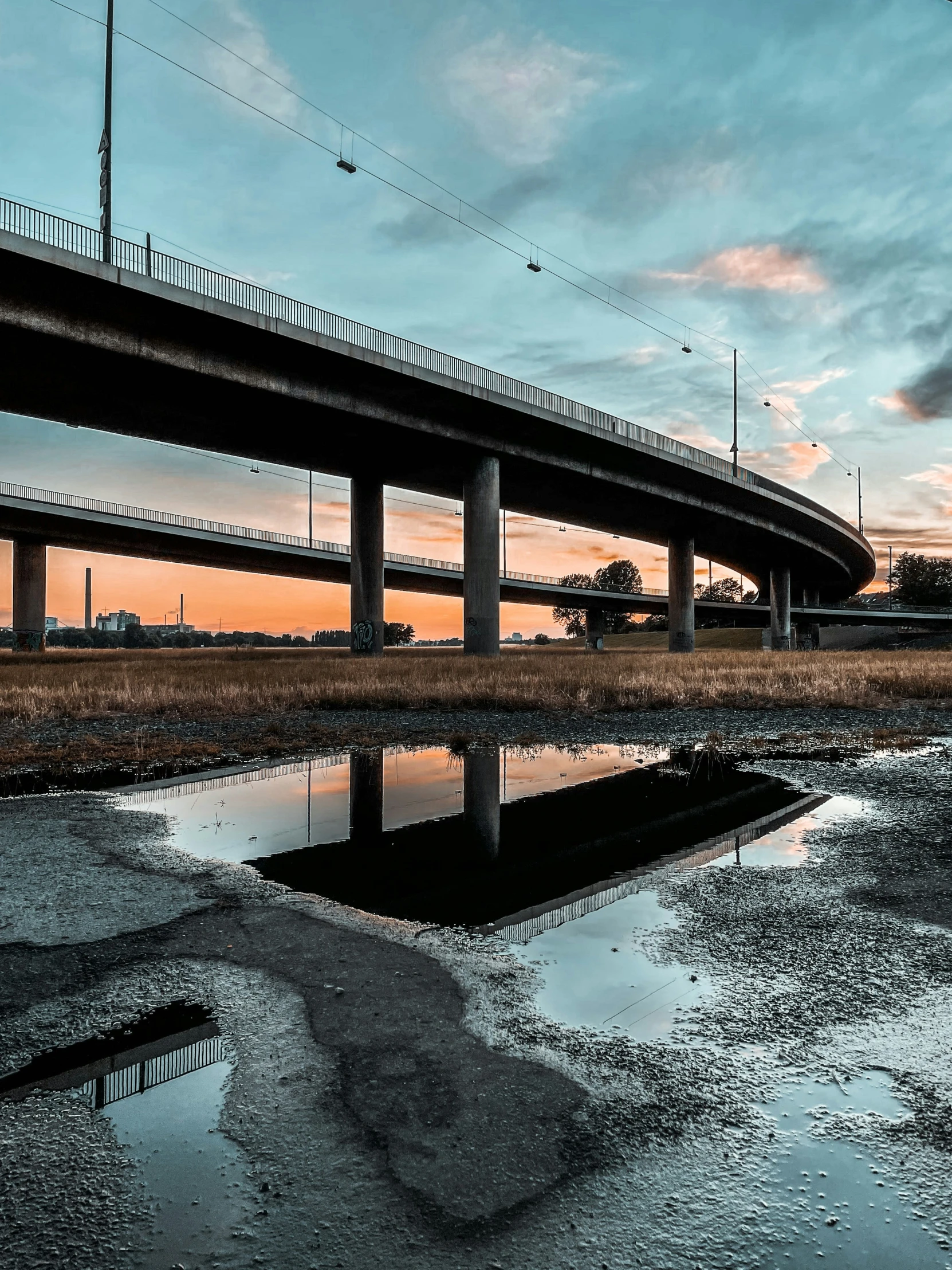 a high - speed train passes over a river with reflection