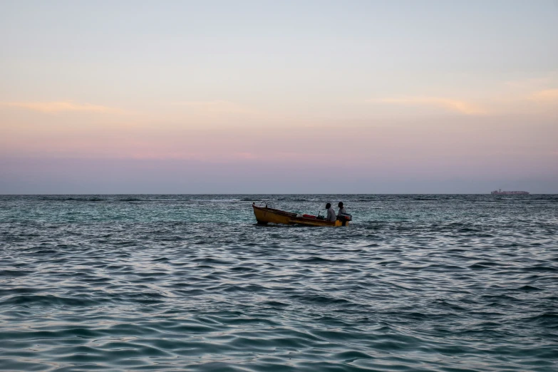 a man in a yellow boat on blue ocean