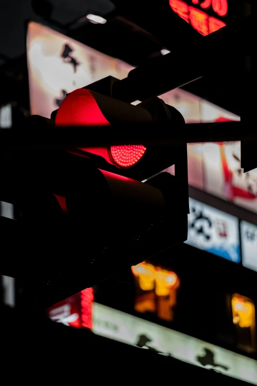 close up of a red traffic light and a restaurant in background