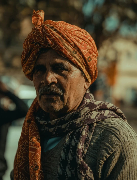 a man with a turban is walking through the streets