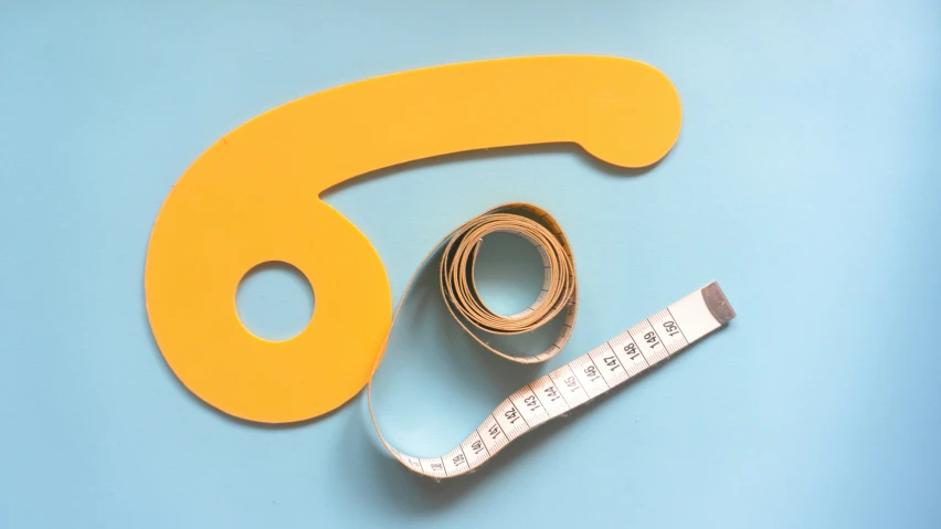 a piece of yellow tape on top of a measuring tape